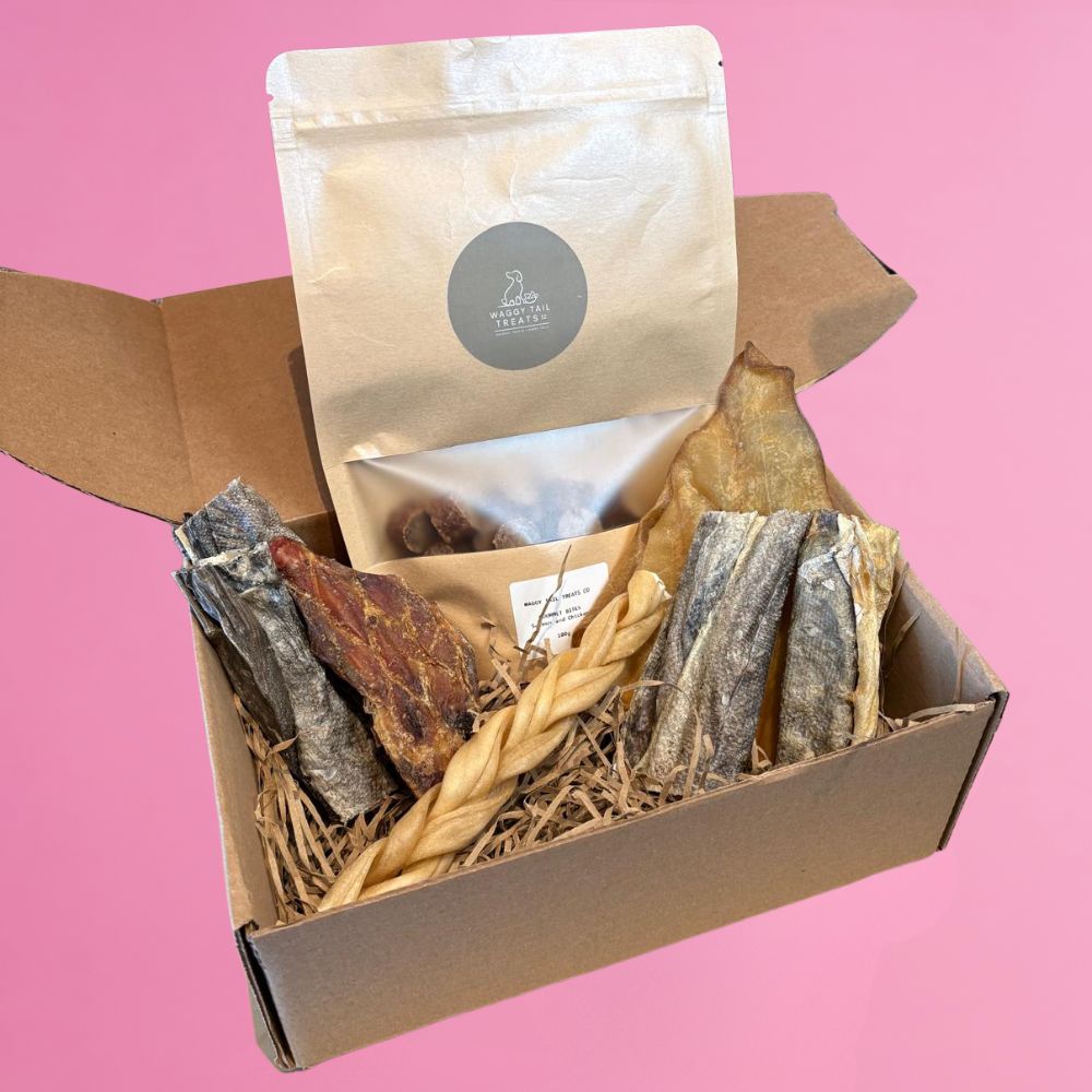 Box of dried fish and a bag on a pink background